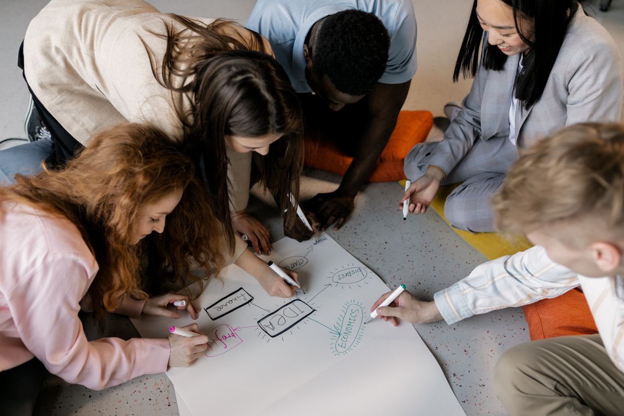 The Art of Drawing Readers In: Your attractive post title goes here A diverse team of young adults collaborating on a startup project with brainstorming sketches.